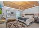 Comfortable bedroom with wood tray ceiling, modern chandelier and large windows at 15810 County Line Rd., Andrews, SC 29510