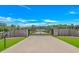 Grand entrance gate featuring a custom monogram and leading to the property at 15810 County Line Rd., Andrews, SC 29510