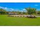 Well-manicured front yard with a circular driveway, lush green lawn, and mature trees at 15810 County Line Rd., Andrews, SC 29510