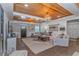 Elegant living room featuring wood ceiling, shiplap walls, cozy seating, and plenty of natural light at 15810 County Line Rd., Andrews, SC 29510