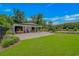 Well-maintained outbuilding with a generous parking area and lush green lawn at 15810 County Line Rd., Andrews, SC 29510