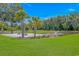 Serene outdoor space featuring palm trees, lounge seating, and a tranquil fountain by the pond at 15810 County Line Rd., Andrews, SC 29510