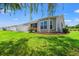 Manicured lawn and landscaping surround this home's backyard, complete with white fencing and a screened porch at 1590 Palmina Loop # A, Myrtle Beach, SC 29588