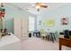A bright bedroom features a ceiling fan and a desk, creating a comfortable and productive space at 1590 Palmina Loop # A, Myrtle Beach, SC 29588