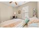 A bright bedroom features a ceiling fan and a window with blinds, creating a cozy and inviting space at 1590 Palmina Loop # A, Myrtle Beach, SC 29588