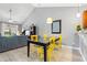 Dining area with stylish yellow chairs, modern decor, and wood-style flooring at 1590 Palmina Loop # A, Myrtle Beach, SC 29588