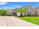 Charming single-story home with a manicured lawn, large driveway, and attached two-car garage at 1590 Palmina Loop # A, Myrtle Beach, SC 29588