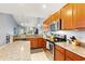 Spacious kitchen with granite counters, stainless appliances, and hardwood cabinetry overlooking the living area at 1590 Palmina Loop # A, Myrtle Beach, SC 29588