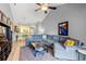 Open-concept living room with hardwood floors flowing to a yellow-themed kitchen and breakfast nook at 1590 Palmina Loop # A, Myrtle Beach, SC 29588