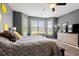 Bright main bedroom with sunny windows, seating area, and a dresser for ample storage space at 1590 Palmina Loop # A, Myrtle Beach, SC 29588