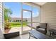 Screened-in back porch with seating, views of the yard and pond at 1590 Palmina Loop # A, Myrtle Beach, SC 29588