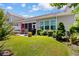 Spacious backyard with a patio set, green grass, and beautiful landscaping at 178 Parmalee Dr. # C, Murrells Inlet, SC 29576
