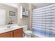 Clean bathroom with storage cabinet, striped shower curtain, and functional fixtures at 178 Parmalee Dr. # C, Murrells Inlet, SC 29576