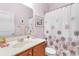 A well-lit bathroom with a decorative shower curtain, a large mirror, and light purple walls at 178 Parmalee Dr. # C, Murrells Inlet, SC 29576