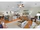 Bright, open-concept living room with hardwood floors, ceiling fan, and seamless flow to the kitchen at 178 Parmalee Dr. # C, Murrells Inlet, SC 29576