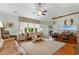 Well-lit living room with vaulted ceiling, hardwood floors, large windows, and stylish decor at 178 Parmalee Dr. # C, Murrells Inlet, SC 29576