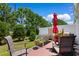 Outdoor patio with comfortable seating, lush greenery, and a red umbrella for shade at 178 Parmalee Dr. # C, Murrells Inlet, SC 29576