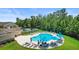 Community pool featuring lounge chairs, sun umbrellas, and meticulously manicured landscaping at 178 Parmalee Dr. # C, Murrells Inlet, SC 29576