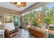 Relaxing sunroom with lots of sunlight, comfortable seating, and a peaceful view of the outdoors at 178 Parmalee Dr. # C, Murrells Inlet, SC 29576