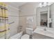 Tidy bathroom featuring tiled walls, bathtub with shower, and single sink vanity with a mirror at 1820 N Ocean Blvd. # 303D, North Myrtle Beach, SC 29582