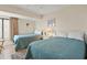Cozy bedroom featuring two twin beds, a nightstand with lamp, and a window with curtains at 1820 N Ocean Blvd. # 303D, North Myrtle Beach, SC 29582