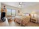 Bright bedroom with a queen bed, beach-themed decor, and a large window at 1820 N Ocean Blvd. # 303D, North Myrtle Beach, SC 29582