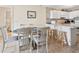 Bright kitchen and dining area with white cabinets, seating and natural light, perfect for casual meals at 1820 N Ocean Blvd. # 303D, North Myrtle Beach, SC 29582