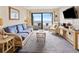 Cozy living room with wicker furnishings and beach view balcony access to enjoy the ocean breeze at 1820 N Ocean Blvd. # 303D, North Myrtle Beach, SC 29582