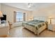 Comfortable bedroom with a queen bed, neutral tones, large window and a ceiling fan at 1820 N Ocean Blvd. # 303D, North Myrtle Beach, SC 29582