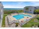 Aerial photograph showcasing outdoor condominium swimming pool, beach access and building exterior at 1820 N Ocean Blvd. # 303D, North Myrtle Beach, SC 29582