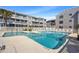 Inviting condominium swimming pool featuring 4-foot depth markers and poolside furniture at 1820 N Ocean Blvd. # 303D, North Myrtle Beach, SC 29582