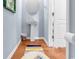 Cozy bathroom with a pedestal sink, oval mirror, and hardwood floors at 1857 Culbertson Ave. # 1857, Myrtle Beach, SC 29577