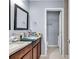 Bathroom showcasing double vanity with granite countertop, dark wood cabinets, and tiled floors at 1857 Culbertson Ave. # 1857, Myrtle Beach, SC 29577
