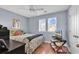 Bedroom features hardwood floors, neutral paint, natural light, and a ceiling fan at 1857 Culbertson Ave. # 1857, Myrtle Beach, SC 29577