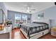 Bedroom boasts a modern bed, light blue walls, two windows, and wood-look floors at 1857 Culbertson Ave. # 1857, Myrtle Beach, SC 29577