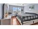 Bedroom boasts a modern bed, light blue walls, two windows, and wood-look floors at 1857 Culbertson Ave. # 1857, Myrtle Beach, SC 29577