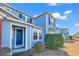 Charming two-story blue townhome featuring well-maintained landscaping and a welcoming entrance at 1857 Culbertson Ave. # 1857, Myrtle Beach, SC 29577