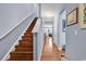 Hallway features hardwood floors, a staircase to the upper level, and artwork on the light blue walls at 1857 Culbertson Ave. # 1857, Myrtle Beach, SC 29577