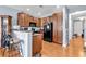 Kitchen with wood cabinets, black appliances, breakfast bar, and hardwood floors at 1857 Culbertson Ave. # 1857, Myrtle Beach, SC 29577