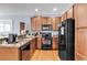 Kitchen with a sleek black appliance suite, wood cabinets, and a kitchen sink at 1857 Culbertson Ave. # 1857, Myrtle Beach, SC 29577