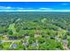 Aerial view of a property near a golf course surrounded by a beautiful landscape with tall trees and clear blue sky at 189 Aspen Loop, Pawleys Island, SC 29585