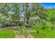 Landscaped backyard with a greenhouse and vegetable garden on a sunny day at 189 Aspen Loop, Pawleys Island, SC 29585