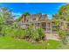 The home's backyard features gardens, a screened-in porch and patio seating at 189 Aspen Loop, Pawleys Island, SC 29585