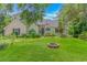 Charming home featuring lush lawn, stone firepit, and inviting landscaping framing the entrance at 189 Aspen Loop, Pawleys Island, SC 29585