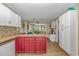 Spacious kitchen with tile countertops, colorful cabinetry, and an adjoining dining area perfect for entertaining at 189 Aspen Loop, Pawleys Island, SC 29585