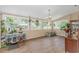 Bright sunroom with lots of natural light, wood look floors and numerous plants at 189 Aspen Loop, Pawleys Island, SC 29585