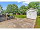 Spacious backyard featuring a concrete driveway, patio area, and a storage shed at 203 Lakeland Dr., Conway, SC 29526