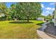 Spacious backyard features a lush green lawn, mature trees, and ample space for outdoor activities at 203 Lakeland Dr., Conway, SC 29526