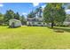 Expansive backyard with lush green lawn, storage shed, and mature trees at 203 Lakeland Dr., Conway, SC 29526