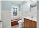 Bathroom with a window, vanity, white fixtures, and ample lighting at 203 Lakeland Dr., Conway, SC 29526